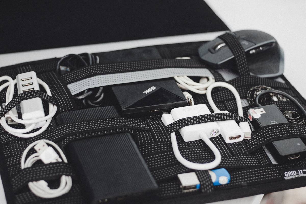 Wall-mounted gaming controller rack holding VR controllers neatly with integrated charging
