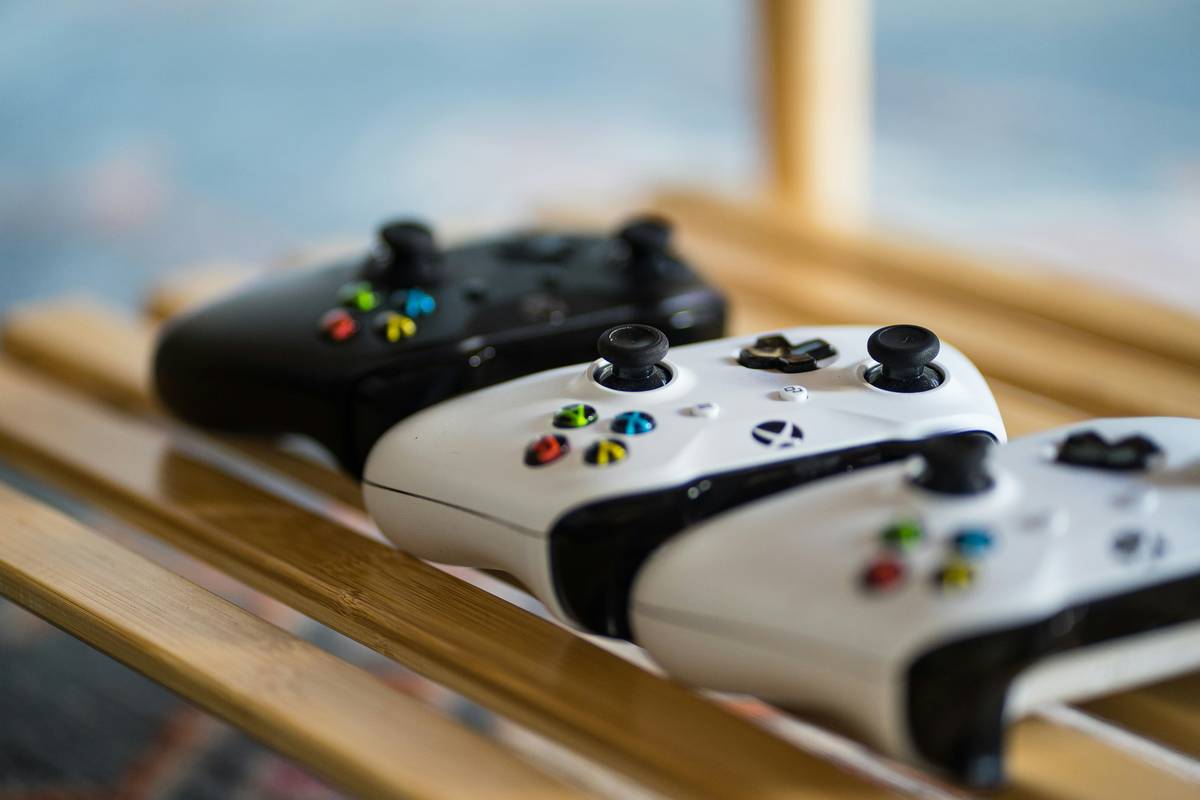 Close-up of gaming controller rack showing ergonomic vertical placement of VR controllers