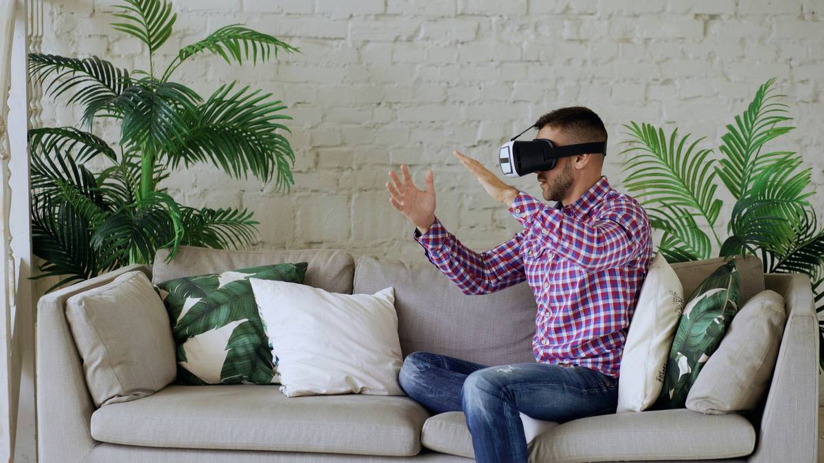 Player triggering a gaming controller emote with wrist flick in VR headset