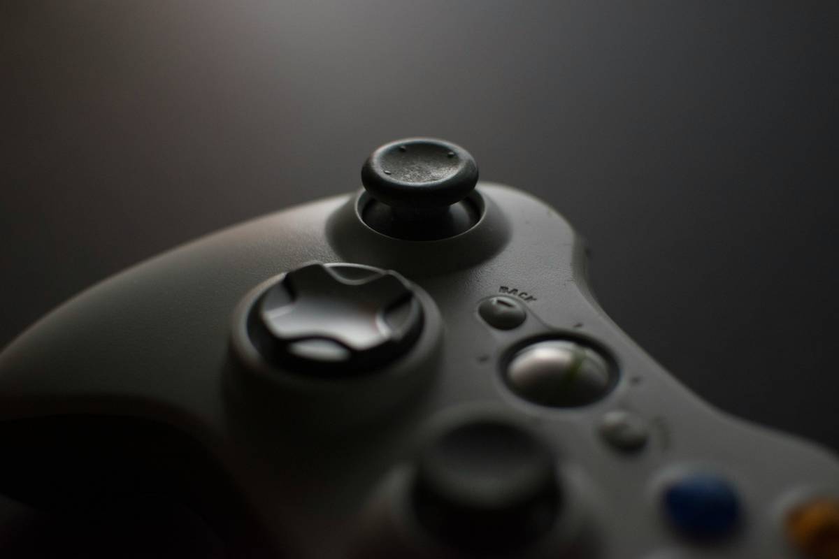 Gaming controller elite held in hand during VR gameplay showing ergonomic design and thumbstick layout